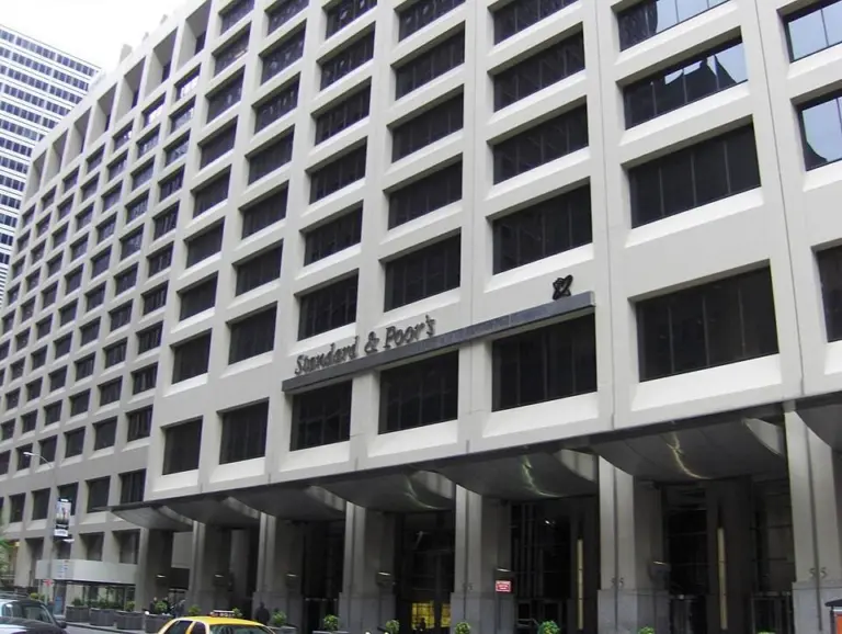 S&P Global Ratings analysts review risk data on a screen for crypto yield vaults and DeFi disclosures